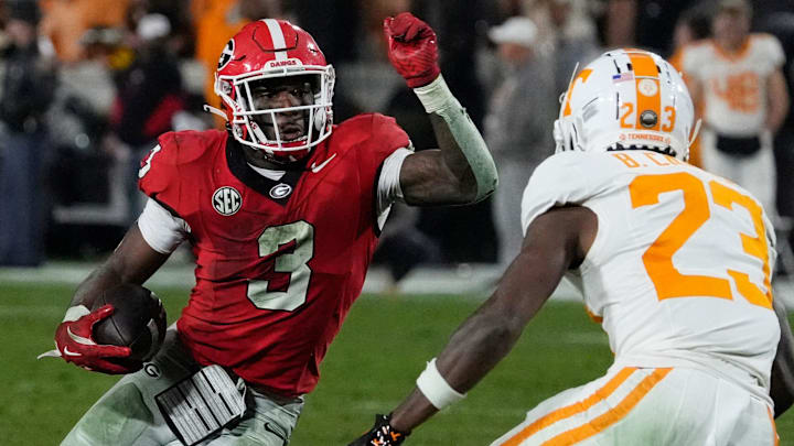 Georgia running back Nate Frazier (3) avoids a tackle from Tennessee defensive back Boo Carter (23) during the second half of a NCAA college football game against Tennessee in Athens, Ga., on Saturday, Nov. 16, 2024.