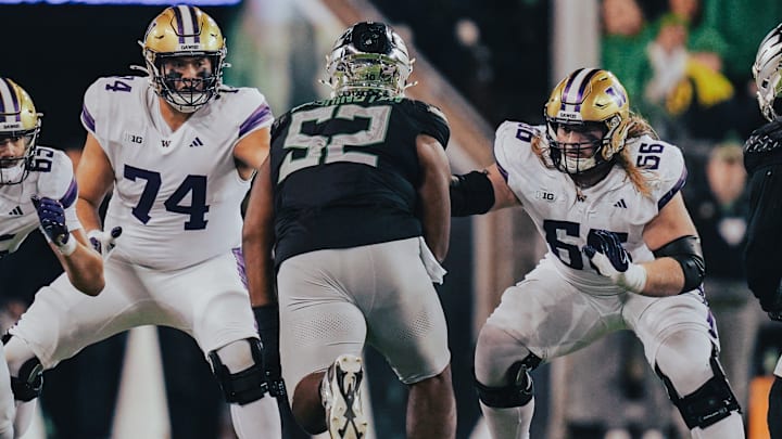 Huskies Drew Azzopardi (74) and Landen Hatchett (66) form pocket protection against Oregon. 