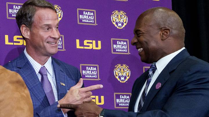Dec 1, 2025; Baton Rouge, LA, USA; LSU new head coach Lane Kiffin, left, and LSU athletic director Verge Ausberry greet each other at South Stadium Club at Tiger Stadium. Mandatory Credit: Matthew Hinton-Imagn Images Dec 1, 2025; Baton Rouge, LA, USA; LSU new head coach Lane Kiffin, left, and LSU athletic director Verge Ausberry greet each other at South Stadium Club at Tiger Stadium. Mandatory Credit: Matthew Hinton-Imagn Images