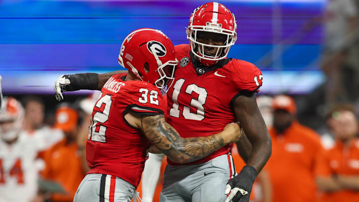 Aug 31, 2024; Atlanta, Georgia, USA; Georgia Bulldogs defensive lineman Mykel Williams (13) celebrates after a tackle with linebacker Chaz Chambliss (32) against the Clemson Tigers in the third quarter at Mercedes-Benz Stadium. Mandatory Credit: Brett Davis-Imagn Images