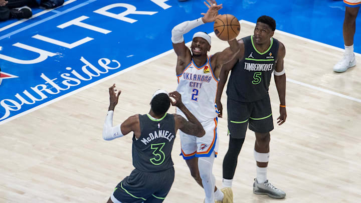 May 20, 2025; Oklahoma City, Oklahoma, USA; Oklahoma City Thunder guard Shai Gilgeous-Alexander (2) and Minnesota Timberwolves forward Jaden McDaniels (3) fight for a rebound in the fourth quarter during game one of the western conference finals for the 2025 NBA Playoffs at Paycom Center. Mandatory Credit: Brett Rojo-Imagn Images