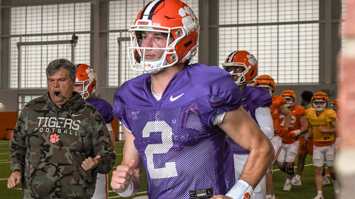 Clemson quarterback Cade Klubnik (2) runs to the outdoor fields with teammates and coaches during Spring Practice in Clemson, S.C. Monday, March 24, 2025.