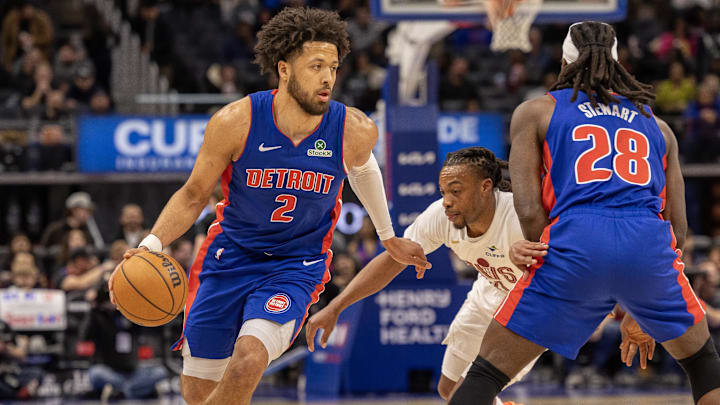 Feb 5, 2025; Detroit, Michigan, USA; Detroit Pistons guard Cade Cunningham (2) moves the ball up court as center Isaiah Stewart (28) sets a pick on Cleveland Cavaliers guard Darius Garland (10) during the first half at Little Caesars Arena. Mandatory Credit: David Reginek-Imagn Images