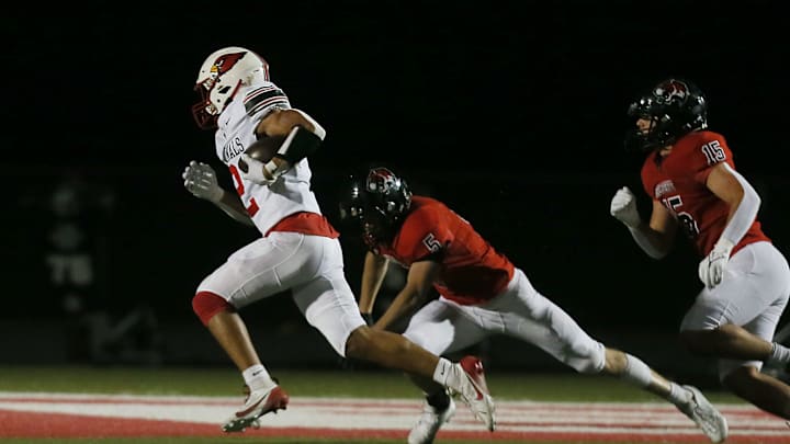 Newton's Isaiah Hansen (2) runs for a touchdown around Gilbert's safety Alden Short (5) during first quarter at Tigers Stadium on Friday, Oct. 18, 2024, in Gilbert, Iowa
