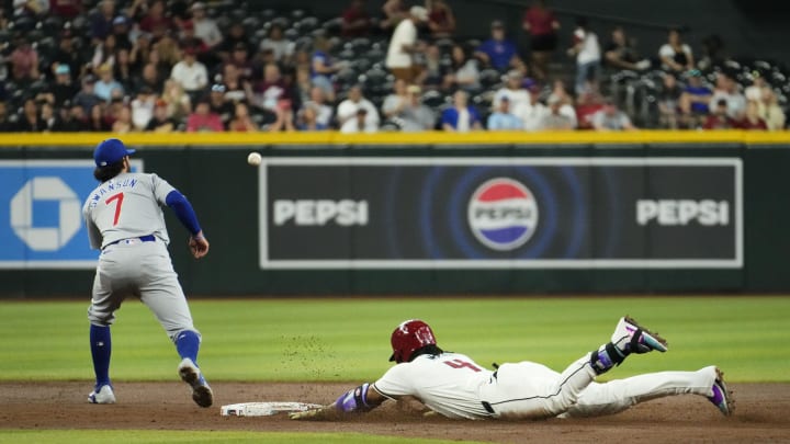Arizona Diamondbacks Ketel Marte (4) slides into second base with a double against Chicago Cubs shortstop Dansby Swanson (7) in the third inning at Chase Field in Phoenix on April 17, 2024. Arizona Diamondbacks Ketel Marte (4) slides into second base with a double against Chicago Cubs shortstop Dansby Swanson (7) in the third inning at Chase Field in Phoenix on April 17, 2024.