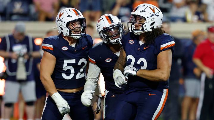 Sep 20, 2025; Charlottesville, Virginia, USA; Virginia Cavaliers defensive lineman Jacob Holmes (23) celebrates with teammates after recording a sack against the Stanford Cardinal during the third quarter at Scott Stadium. Mandatory Credit: Geoff Burke-Imagn Images Sep 20, 2025; Charlottesville, Virginia, USA; Virginia Cavaliers defensive lineman Jacob Holmes (23) celebrates with teammates after recording a sack against the Stanford Cardinal during the third quarter at Scott Stadium. Mandatory Credit: Geoff Burke-Imagn Images