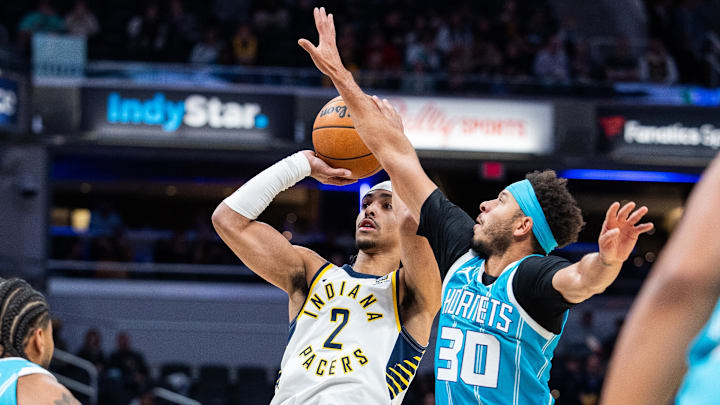 Oct 17, 2024; Indianapolis, Indiana, USA; Indiana Pacers guard Andrew Nembhard (2) shoots the ball while Charlotte Hornets guard Seth Curry (30)  defends in the first quarter at Gainbridge Fieldhouse. Mandatory Credit: Trevor Ruszkowski-Imagn Images