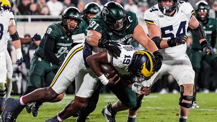 Michigan State defensive lineman Alex VanSumeren (91) tackles Michigan quarterback Bryce Underwood (19) during the second half at Spartan Stadium in East Lansing on Saturday, October 25, 2025.