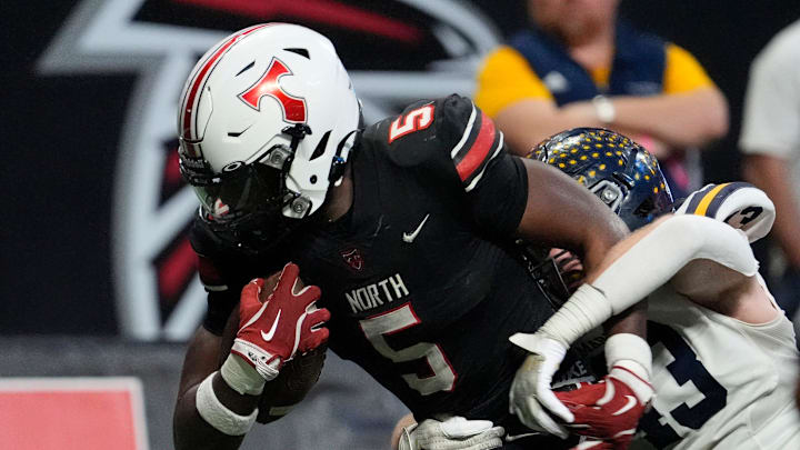 North Oconee's Khamari Brooks (5) breaks a tackle from 	MaristÕs Cullen O'Leary (13) during the GHSA Division 4A Football State Championship game in Atlanta, on Monday, Dec. 16, 2024.