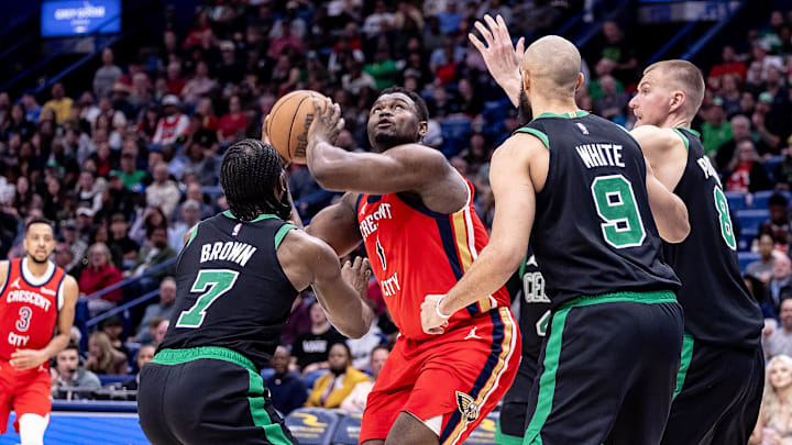 Mar 30, 2024; New Orleans, Louisiana, USA; New Orleans Pelicans forward Zion Williamson (1) shoots the ball over Boston Celtics guard Jaylen Brown (7) and guard Derrick White (9) and center Kristaps Porzingis (8) during the second half at Smoothie King Center. Mandatory Credit: Stephen Lew-Imagn Images Mar 30, 2024; New Orleans, Louisiana, USA; New Orleans Pelicans forward Zion Williamson (1) shoots the ball over Boston Celtics guard Jaylen Brown (7) and guard Derrick White (9) and center Kristaps Porzingis (8) during the second half at Smoothie King Center. Mandatory Credit: Stephen Lew-Imagn Images
