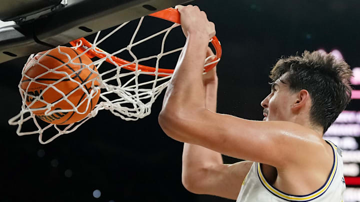 Apr 6, 2026; Indianapolis, IN, USA; Michigan Wolverines center Aday Mara (15) dunks.