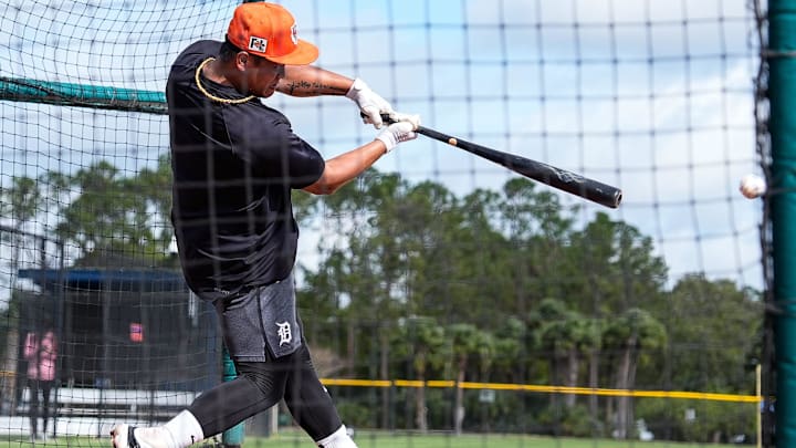 Detroit Tigers prospect Hao-Yu Lee hits the ball during spring training, wearing an orange hat and dark blue shirt. 