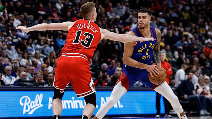 Mar 24, 2025; Denver, Colorado, USA; Denver Nuggets forward Michael Porter Jr. (1) controls the ball against Chicago Bulls guard Kevin Huerter (13) in the third quarter at Ball Arena. Mandatory Credit: Isaiah J. Downing-Imagn Images