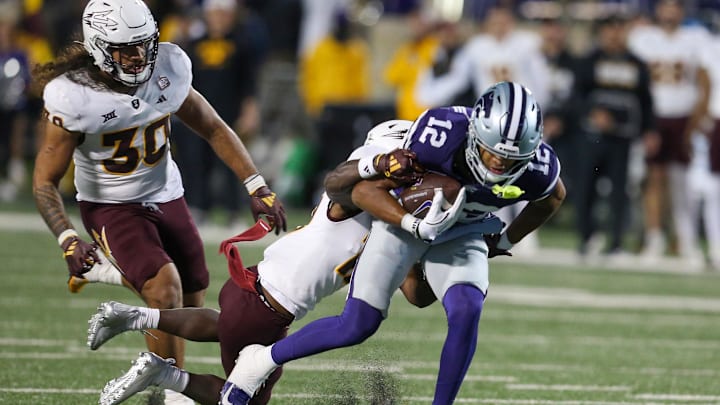 Nov 16, 2024; Manhattan, Kansas, USA; Kansas State Wildcats wide receiver Tre Spivey (12) is tackled by Arizona State Sun Devils defensive back Javan Robinson (12) during the fourth quarter at Bill Snyder Family Football Stadium. Mandatory Credit: Scott Sewell-Imagn Images