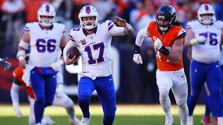 Buffalo Bills quarterback Josh Allen (17) runs against Denver Broncos linebacker Karene Reid (47) during the second quarter of an AFC Divisional Round playoff game at Empower Field at Mile High.