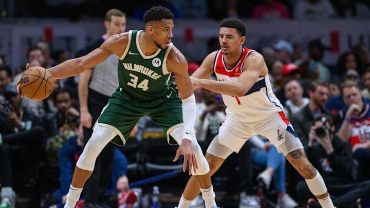 Apr 2, 2024; Washington, District of Columbia, USA; Milwaukee Bucks forward Giannis Antetokounmpo (34) dribbles while being defended by Washington Wizards guard Johnny Davis (1) during the third quarter at Capital One Arena. Mandatory Credit: Reggie Hildred-Imagn Images