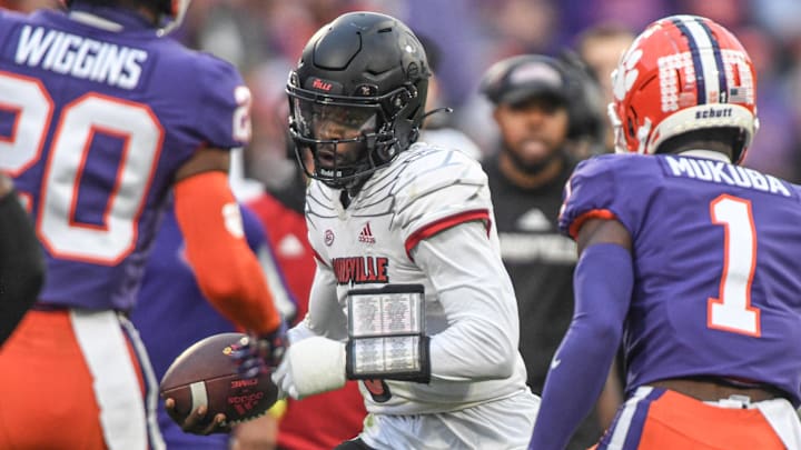 Nov 12, 2022; Clemson, South Carolina, USA; Louisville quarterback Malik Cunningham (3) runs near Clemson safety Andrew Mukuba (1) and cornerback Nate Wiggins (20) during the second quarter at Memorial Stadium in Clemson, South Carolina Saturday, Nov. 12, 2022.  