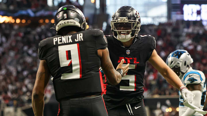 Jan 5, 2025; Atlanta, Georgia, USA; Atlanta Falcons quarterback Michael Penix Jr. (9) celebrates with wide receiver Drake London (5) after a touchdown run against the Carolina Panthers in the second quarter at Mercedes-Benz Stadium. Mandatory Credit: Brett Davis-Imagn Images
