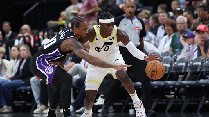 Oct 15, 2024; Salt Lake City, Utah, USA; Sacramento Kings forward DeMar DeRozan (10) reaches for the ball of Utah Jazz forward Taylor Hendricks (0) during the third quarter at Delta Center. Mandatory Credit: Rob Gray-Imagn Images
