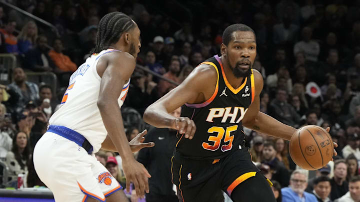 Dec 15, 2023; Phoenix, Arizona, USA; Phoenix Suns forward Kevin Durant (35) drives on New York Knicks guard Immanuel Quickley (5) in the first half at Footprint Center. Mandatory Credit: Rick Scuteri-Imagn Images