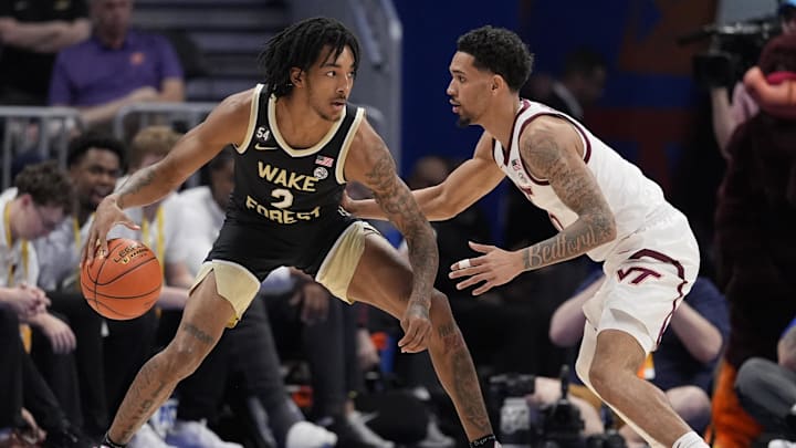 Mar 10, 2026; Charlotte, NC, USA; Wake Forest Demon Deacons forward Juke Harris (2) handles the ball guarded by Virginia Tech Hokies guard Jailen Bedford (0) during the first half at Spectrum Center.