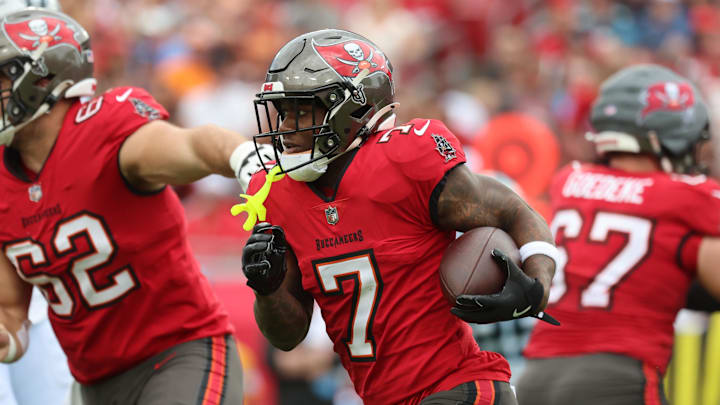 Dec 29, 2024; Tampa, Florida, USA; Tampa Bay Buccaneers running back Bucky Irving (7) carries the ball against the Carolina Panthers during the first quarter at Raymond James Stadium. Mandatory Credit: Kim Klement Neitzel-Imagn Images