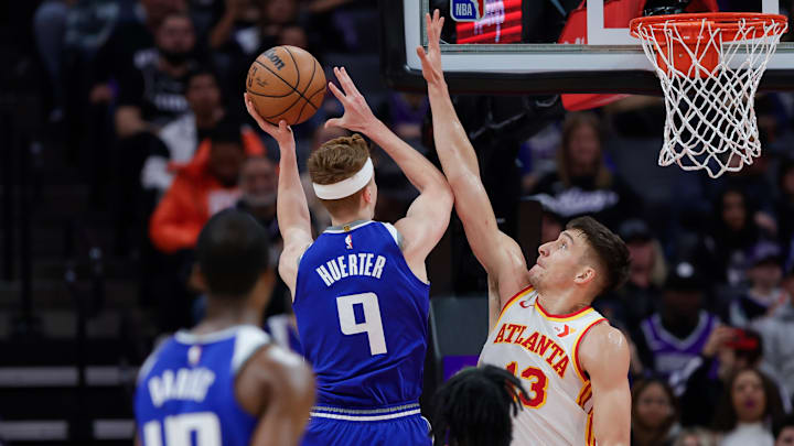Jan 22, 2024; Sacramento, California, USA; Sacramento Kings guard Kevin Huerter (9) drives to the basket against Atlanta Hawks guard Bogdan Bogdanovic (13) during the first quarter at Golden 1 Center. Mandatory Credit: Sergio Estrada-Imagn Images