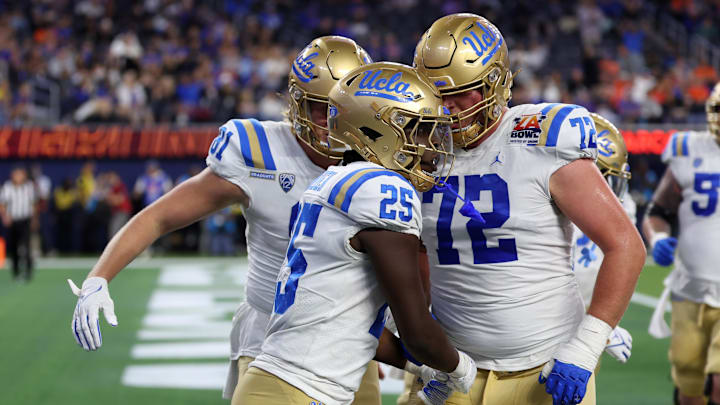 Dec 16, 2023; Inglewood, CA, USA; UCLA Bruins running back TJ Harden (25) celebrates with offensive lineman Garrett DiGiorgio (72) after scoring a touchdown during the third quarter of the LA Bowl at SoFi Stadium. Mandatory Credit: Kiyoshi Mio-Imagn Images