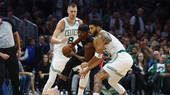 Oct 27, 2023; Boston, Massachusetts, USA; Miami Heat forward Jimmy Butler (22) looks to get away from Boston Celtics forward Jayson Tatum (0) and center Kristaps Porzingis (8) during the second half at TD Garden. Mandatory Credit: Winslow Townson-Imagn Images Oct 27, 2023; Boston, Massachusetts, USA; Miami Heat forward Jimmy Butler (22) looks to get away from Boston Celtics forward Jayson Tatum (0) and center Kristaps Porzingis (8) during the second half at TD Garden. Mandatory Credit: Winslow Townson-Imagn Images