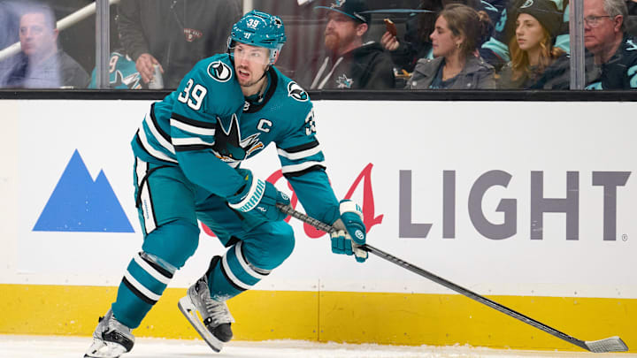 Jan 30, 2024; San Jose, California, USA; San Jose Sharks center Logan Couture (39) plays the puck against the Seattle Kraken during the second period at SAP Center at San Jose. Mandatory Credit: Robert Edwards-Imagn Images