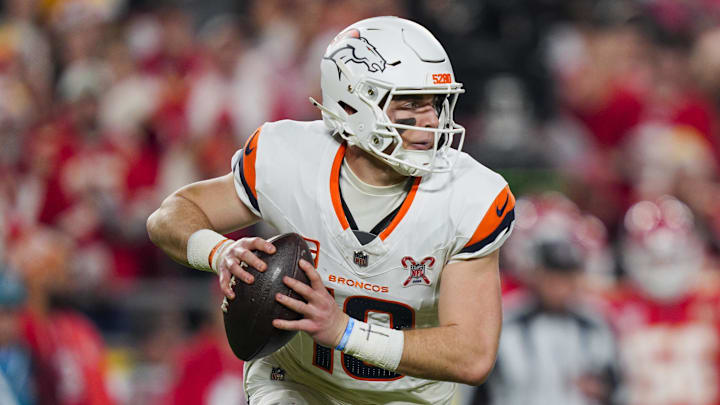 Denver Broncos quarterback Bo Nix (10) rolls out to pass during the first half against the Kansas City Chiefs at GEHA Field at Arrowhead Stadium. Denver Broncos quarterback Bo Nix (10) rolls out to pass during the first half against the Kansas City Chiefs at GEHA Field at Arrowhead Stadium.
