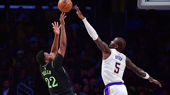 Nov 30, 2025; Los Angeles, California, USA; New Orleans Pelicans center Derik Queen (22) shoots against Los Angeles Lakers center Deandre Ayton (5) during the first half at Crypto.com Arena. Mandatory Credit: Gary A. Vasquez-Imagn Images