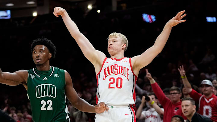 Ohio State Buckeyes forward Colin White (20) shoots a three pointer over Ohio Bobcats forward Jalen Breath (22) during the NCAA preseason exhibition game at Value City Arena in Columbus on Oct. 26, 2025. Ohio State won 103-74. Ohio State Buckeyes forward Colin White (20) shoots a three pointer over Ohio Bobcats forward Jalen Breath (22) during the NCAA preseason exhibition game at Value City Arena in Columbus on Oct. 26, 2025. Ohio State won 103-74.