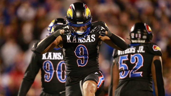 Kansas redshirt sophomore defensive lineman Austin Booker (9) reacts after a sack in the fourth