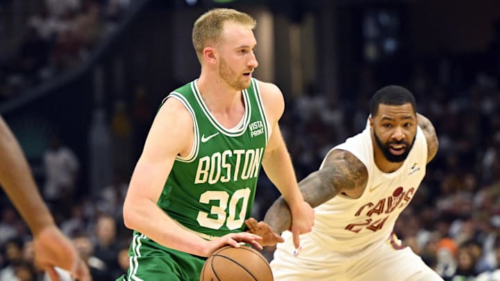 May 11, 2024; Cleveland, Ohio, USA: Boston Celtics forward Sam Hauser (30) dribbles the ball against Cleveland Cavaliers forward Marcus Morris Sr. (24) in the second quarter of game three of the second round of the 2024 NBA playoffs at Rocket Mortgage FieldHouse. Mandatory Credit: David Richard-Imagn Images