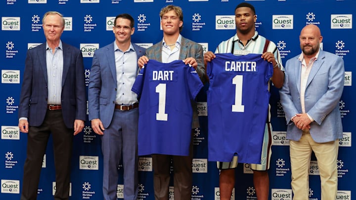 Apr 25, 2025; East Rutherford, NJ, US; New York Giants president John Mara (far left), general manager Joe Schoen (left), Jaxson Dart, Abdul Carter, and head coach Brian Daboll (right) pose for photos prior to the start of the press conference to introduce the Giants first round draft picks.  Mandatory Credit: Thomas Salus-Imagn Images