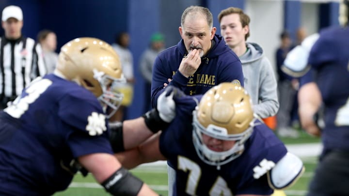 Notre Dame offensive line coach Joe Rudolph (holding his whistle) watches intently as offensive guard Billy Schrauth (74) and a teammate go through drills Saturday, March 25, 2023, at Notre Dame spring football practice in South Bend.

Nd Fb Practice 03252023