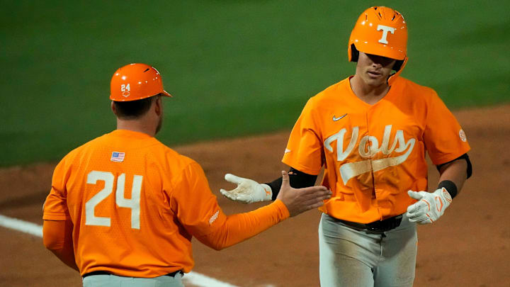 Mar 21, 2025; Tuscaloosa AL, USA; Tennessee infielder Dean Curley (1) is congratulated by the third base coach after hitting a two-run homer against Alabama in game two of the series at Sewell-Thomas Stadium.