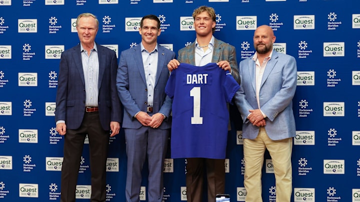 Apr 25, 2025; East Rutherford, NJ, US; New York Giants president John Mara (far left), general manager Joe Schoen (left), Jaxson Dart, and head coach Brian Daboll (right) pose for photos prior to the start of the press conference to introduce the Giants first round draft picks.  Mandatory Credit: Thomas Salus-Imagn Images