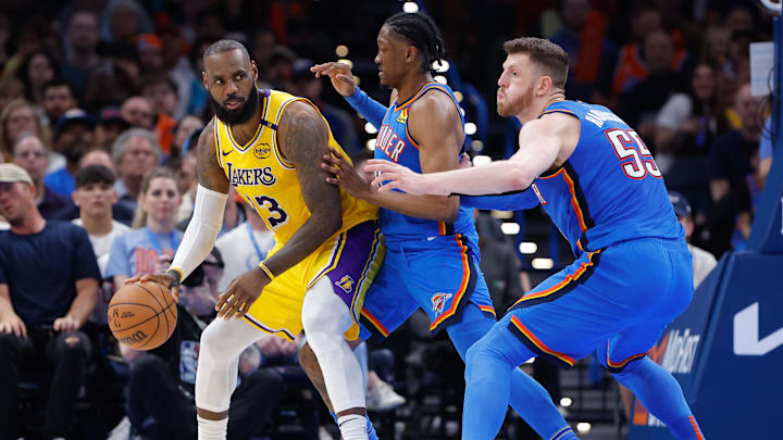 Apr 8, 2025; Oklahoma City, Oklahoma, USA; Los Angeles Lakers forward LeBron James (23) moves the ball as Oklahoma City Thunder forward Jalen Williams (8) and center Isaiah Hartenstein (55) defend the play during the second half at Paycom Center. Mandatory Credit: Alonzo Adams-Imagn Images Apr 8, 2025; Oklahoma City, Oklahoma, USA; Los Angeles Lakers forward LeBron James (23) moves the ball as Oklahoma City Thunder forward Jalen Williams (8) and center Isaiah Hartenstein (55) defend the play during the second half at Paycom Center. Mandatory Credit: Alonzo Adams-Imagn Images