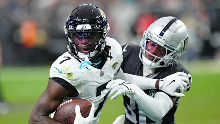 Dec 22, 2024; Paradise, Nevada, USA; Las Vegas Raiders cornerback Darnay Holmes (30) looks to knock the ball away from Jacksonville Jaguars wide receiver Brian Thomas Jr. (7) during the second quarter at Allegiant Stadium. Mandatory Credit: Stephen R. Sylvanie-Imagn Images Dec 22, 2024; Paradise, Nevada, USA; Las Vegas Raiders cornerback Darnay Holmes (30) looks to knock the ball away from Jacksonville Jaguars wide receiver Brian Thomas Jr. (7) during the second quarter at Allegiant Stadium. Mandatory Credit: Stephen R. Sylvanie-Imagn Images