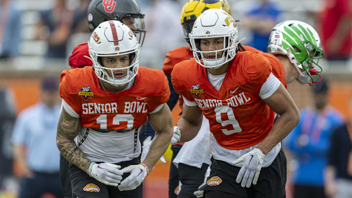 Jan 30, 2025; Mobile, AL, USA; National team wide receiver Jaylin Noel of Iowa State (12) and National team wide receiver Jayden Higgins of Iowa State (9) work through drills during Senior Bowl practice for the National team at Hancock Whitney Stadium. Mandatory Credit: Vasha Hunt-Imagn Images