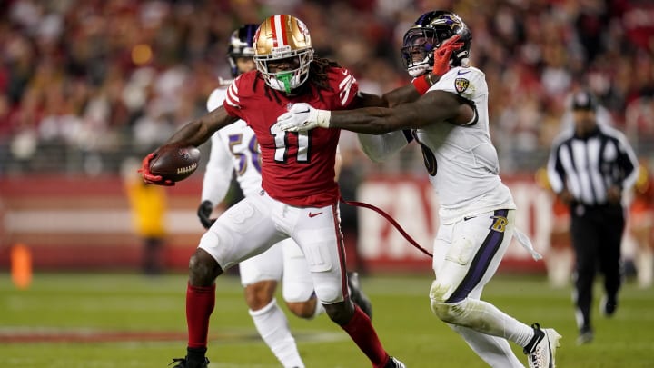 Dec 25, 2023; Santa Clara, California, USA; San Francisco 49ers wide receiver Brandon Aiyuk (11) runs with the ball next to Baltimore Ravens linebacker Patrick Queen (6) in the fourth quarter at Levi's Stadium. Mandatory Credit: Cary Edmondson-USA TODAY Sports