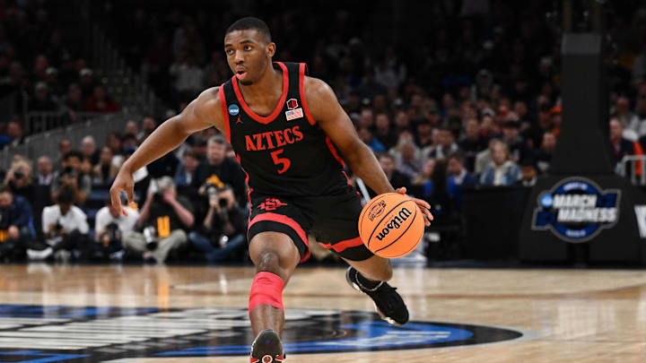 Mar 28, 2024; Boston, MA, USA; San Diego State Aztecs guard Lamont Butler (5) dribbles the ball against the Connecticut Huskies in the semifinals of the East Regional of the 2024 NCAA Tournament at TD Garden. Mandatory Credit: Brian Fluharty-Imagn Images