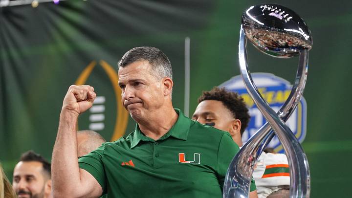 Dec 31, 2025; Arlington, TX, USA; Miami Hurricanes head coach Mario Cristobal with the champions trophy following the 2025 Cotton Bowl and quarterfinal game of the College Football Playoff against the Ohio State Buckeyes at AT&T Stadium. Mandatory Credit: Raymond Carlin III-Imagn Images