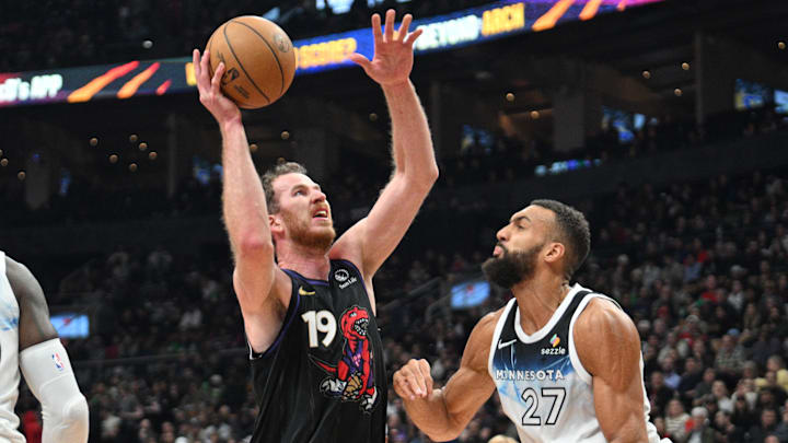 Nov 21, 2024; Toronto, Ontario, CAN;  Toronto Raptors center Jakob Poeltl (19) shoots the ball as Minnesota Timberwolves center Rudy Gobert (27) defends in the first half at Scotiabank Arena. Mandatory Credit: Dan Hamilton-Imagn Images