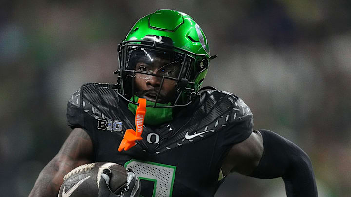 Oregon Ducks defensive back Nikko Reed (9) rushes up the field after an interception Saturday, Dec. 7, 2024, during the Big Ten Championship game at Lucas Oil Stadium in Indianapolis.