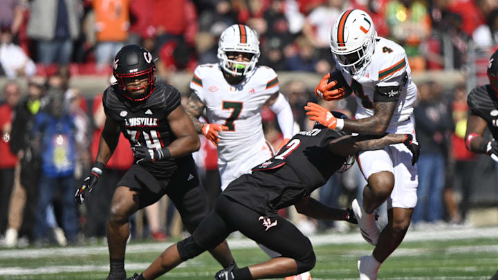 Oct 19, 2024; Louisville, Kentucky, USA;   Miami Hurricanes running back Mark Fletcher Jr. (4) runs the ball against Louisville Cardinals defensive back Tamarion McDonald (12) during the first half at L&N Federal Credit Union Stadium. Miami defeated Louisville 52-45. Mandatory Credit: Jamie Rhodes-Imagn Images