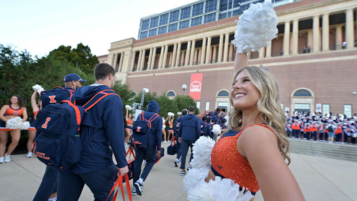 Sep 27, 2025; Champaign, Illinois, USA;  Members of the Illinettes Dance Team welcomes Illinois Fighting Illini players before an NCAA football game with the Southern California Trojans at Memorial Stadium. Mandatory Credit: Ron Johnson-Imagn Images