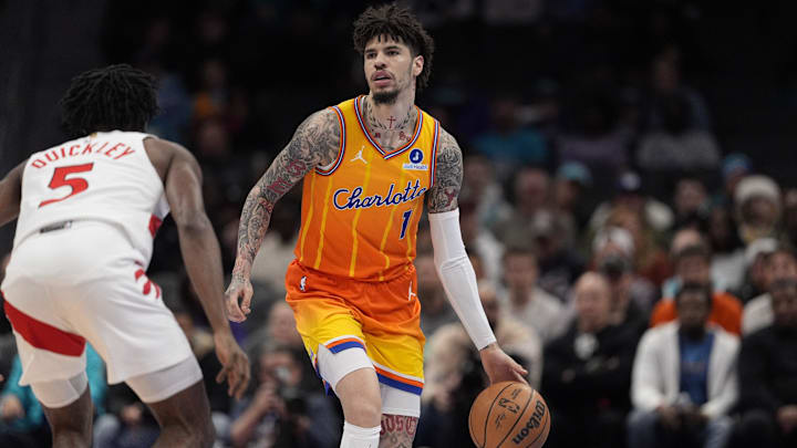 Nov 29, 2025; Charlotte, North Carolina, USA; Charlotte Hornets guard LaMelo Ball (1) brings the ball up court defended by Toronto Raptors guard Immanuel Quickley (5) during the first quarter at Spectrum Center. Mandatory Credit: Jim Dedmon-Imagn Images